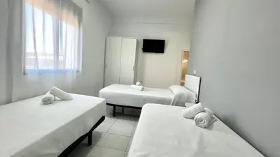 Cama o camas de una habitación en Hostal Carlos III