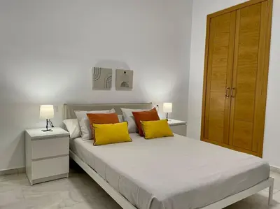 Cama o camas de una habitación en Geysotur Puerta de Magdalena