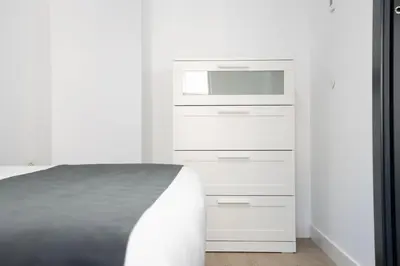 Cama o camas de una habitación en Apartamentos MLC Ciudad de Linares