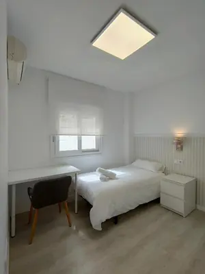 Cama o camas de una habitación en Casa Mallen, con amplia terraza, en el barrio de Nervión