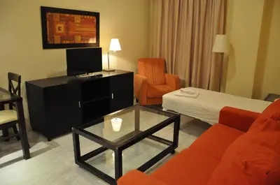 Cama o camas de una habitación en Apartamentos Luxsevilla Palacio