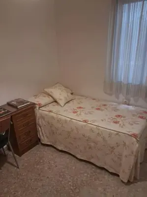 Cama o camas de una habitación en Alojamiento Comercio.