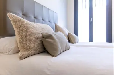 Cama o camas de una habitación en Alohamundi Puerta Osario II