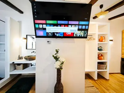 Una televisión o centro de entretenimiento en Casa rural La Cuca