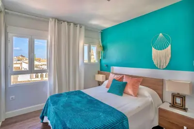 Cama o camas de una habitación en Ático La Muralla con terraza privada