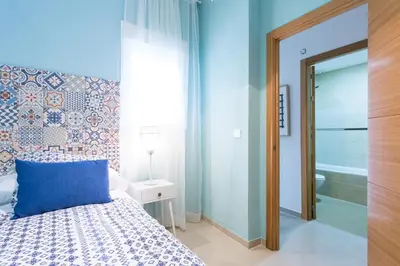 Cama o camas de una habitación en Apartamentos Diaber San Leandro
