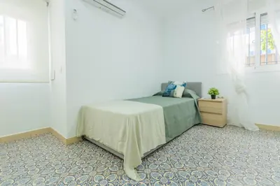 Cama o camas de una habitación en Blue Gardenia Apartmento en Sevilla