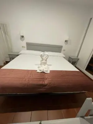 Cama o camas de una habitación en Villa María Hotel