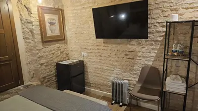 Una televisión o centro de entretenimiento en Arena Centro Rooms&Suites, by Homing U
