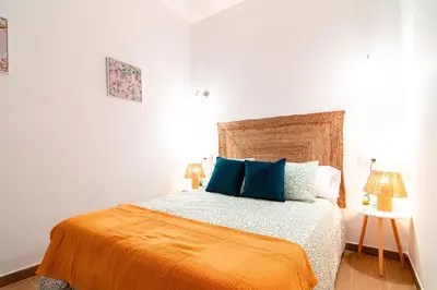 Cama o camas de una habitación en Edomus El Patio de la Macarena