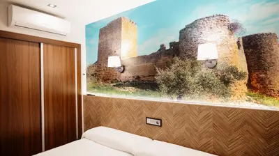 Cama o camas de una habitación en Hostal Central Marmolejo