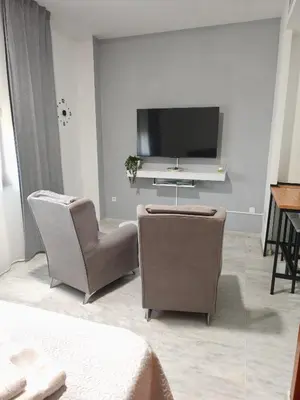 Una televisión o centro de entretenimiento en Apartamento FIBES II edificio LUX SEVILLA