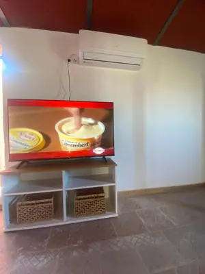 Una televisión o centro de entretenimiento en Olimpya Rural Apartments