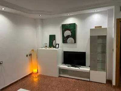 Una televisión o centro de entretenimiento en Apartamento espacioso El Olivo