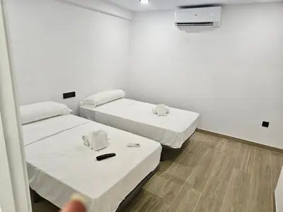 Cama o camas de una habitación en Geysotur Balcón Torre de la Mézquita