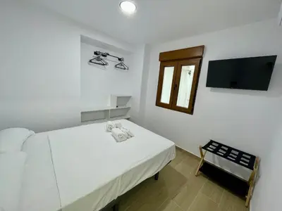 Cama o camas de una habitación en Geysotur Balcón Torre de la Mézquita