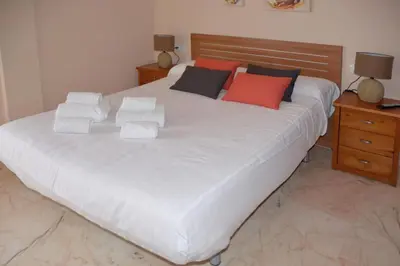 Cama o camas de una habitación en CASA PATIO LAS PALMERAs 1 Y 2