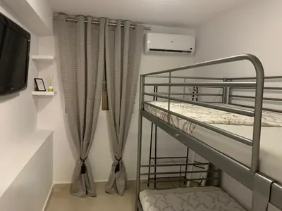 Cama o camas de una habitación en Parque Amate Sevilla