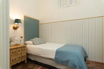 Cama o camas de una habitación en Aitana in Tintes Sevilla's Gem