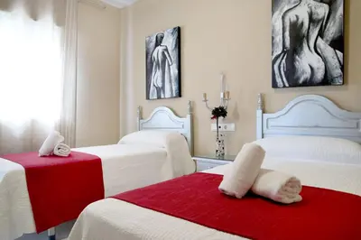 Cama o camas de una habitación en HOSTAL ViCTORiA