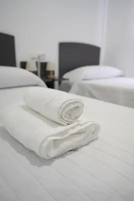 Cama o camas de una habitación en Hostal Las Viñas