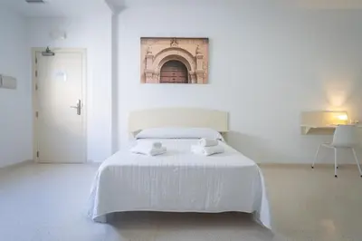 Cama o camas de una habitación en Hostal Las Viñas