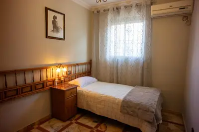 Cama o camas de una habitación en Piso de 3 habitaciones a las afueras de Sevilla