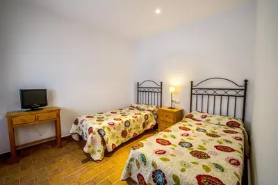 Cama o camas de una habitación en Apartamentos La Venta del Charco