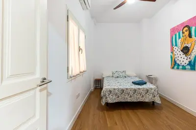 Cama o camas de una habitación en HOUSE SEVILLANA 6 habitaciones