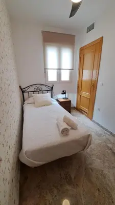 Cama o camas de una habitación en Apartamentos Maria Cristina con parking privado gratis