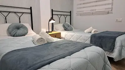 Cama o camas de una habitación en Apartamentos Maria Cristina con parking privado gratis
