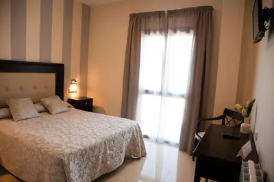 Cama o camas de una habitación en Hotel El Capricho