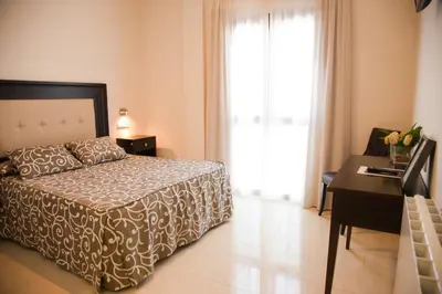 Cama o camas de una habitación en Hotel El Capricho
