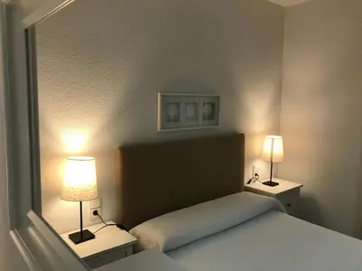 Cama o camas de una habitación en Apartamento Ciudad Jardín con PARKING