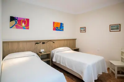 Cama o camas de una habitación en Pensión Dulces Sueños