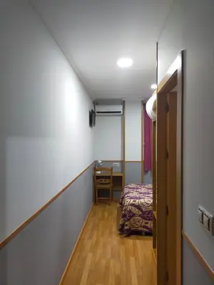Cama o camas de una habitación en Hostal Banderas