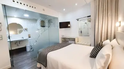 Cama o camas de una habitación en La Boutique Puerta Osario