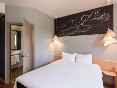 Cama o camas de una habitación en Ibis Sevilla