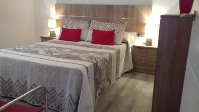 Cama o camas de una habitación en Pompeyos Viviendas Vacacionales