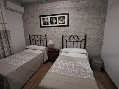 Cama o camas de una habitación en Hostal El Sevillano