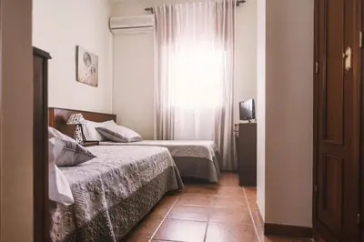 Cama o camas de una habitación en Hostal La Laguna