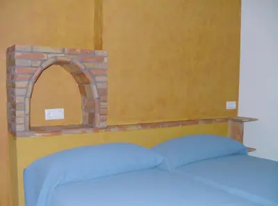 Cama o camas de una habitación en Apartamentos Rurales Alcazaba de las Torres