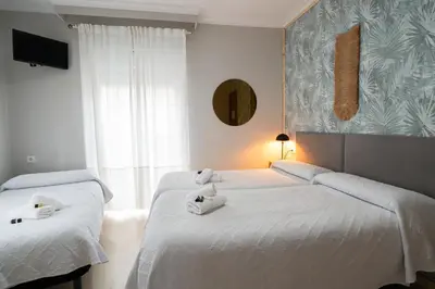 Cama o camas de una habitación en Hostal La Muralla