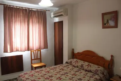 Cama o camas de una habitación en Hostal Santa Ana
