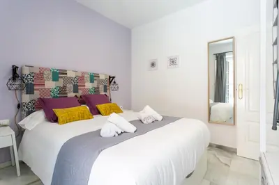 Cama o camas de una habitación en Uniko Home Sevilla