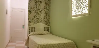 Cama o camas de una habitación en Hostal Macami