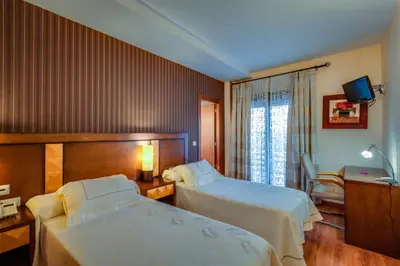 Cama o camas de una habitación en Hotel Ciudad de Martos