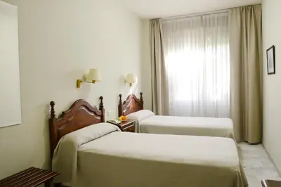 Cama o camas de una habitación en Hotel San Pablo Sevilla
