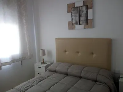 Cama o camas de una habitación en APARTAMENTO PUERTA SEVILLA