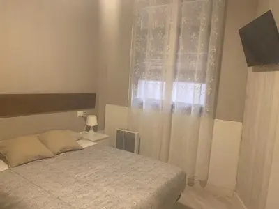 Cama o camas de una habitación en Apto con patio y barbacoa BBQ H de la Reina